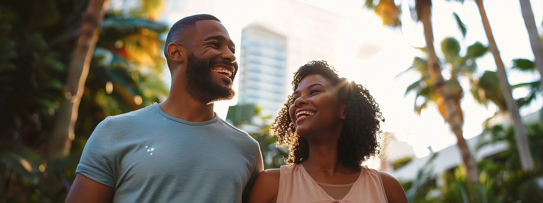 a couple happily exploring different neighborhoods in miami with their real estate agent, discussing first-time homebuyer programs.