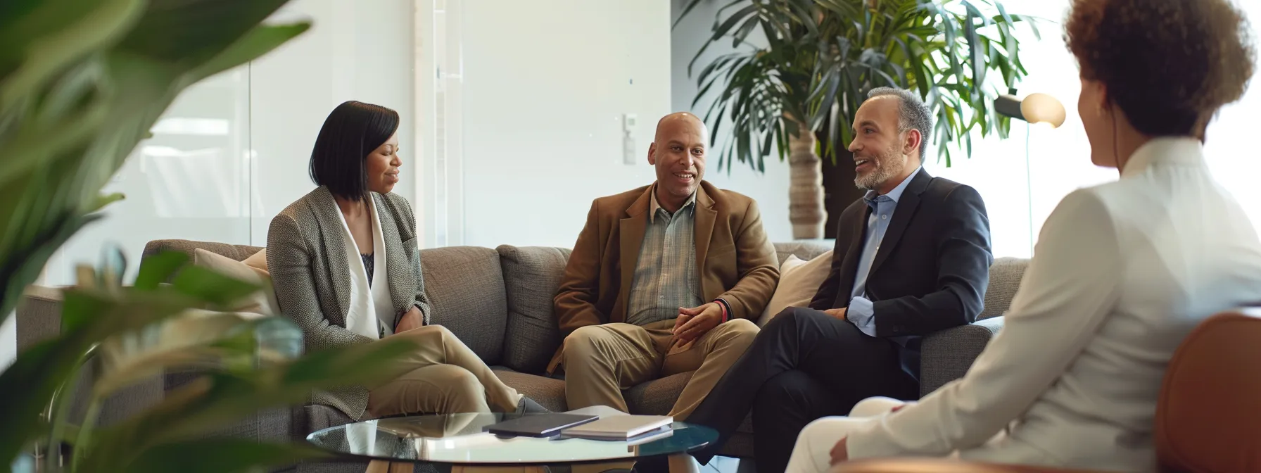 a couple sitting with a hud-approved agent discussing mortgage options in a cozy office in miami.