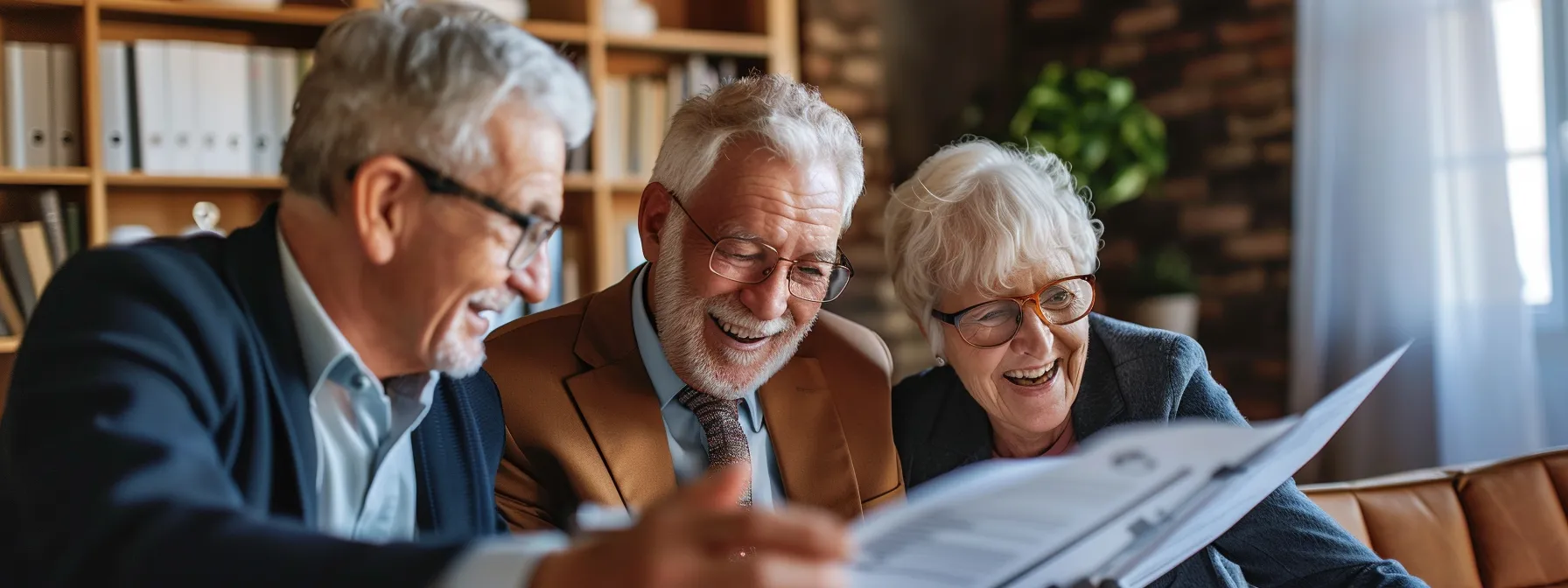 a senior couple smiling as they review financial documents with a mortgage broker.