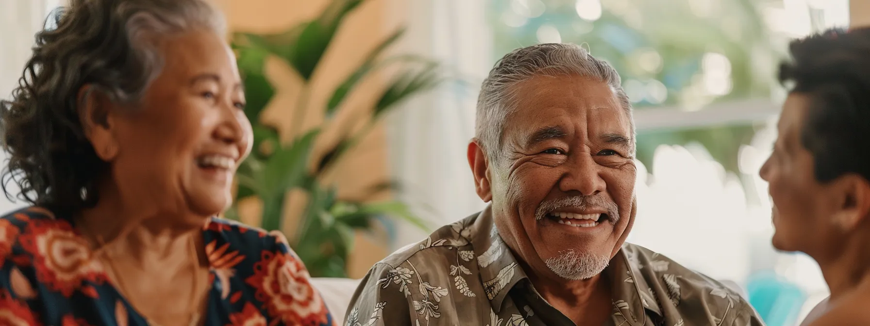 a senior couple smiling as they discuss financial options with a real estate agent in a sunny miami living room.